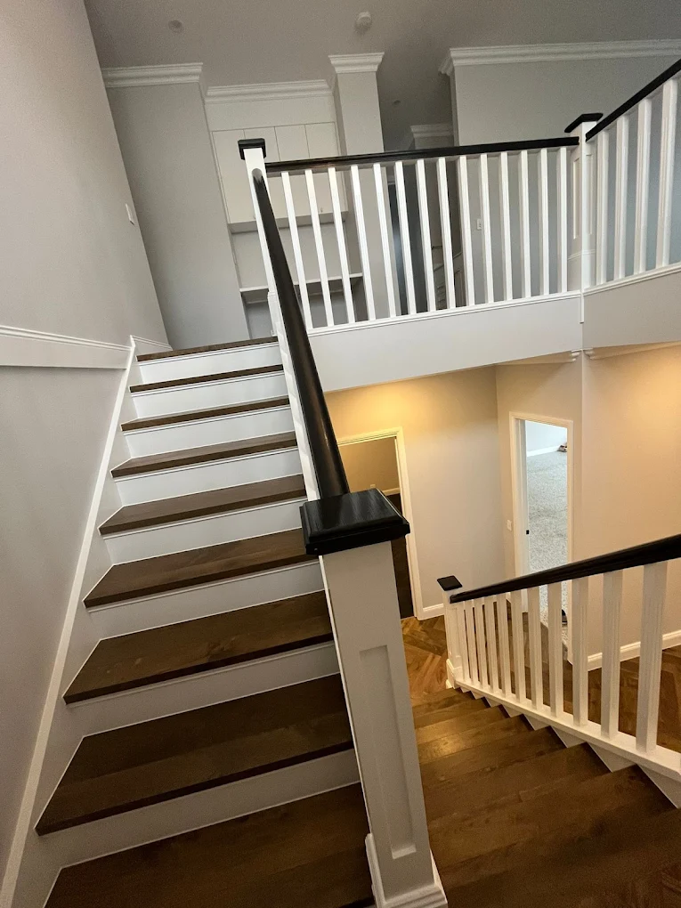 Timber staircase with black handrail